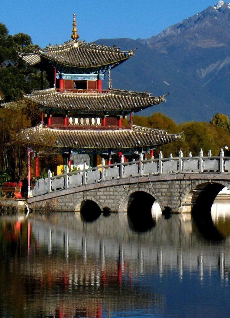 Pagoda and stone bridge reflected in a lake